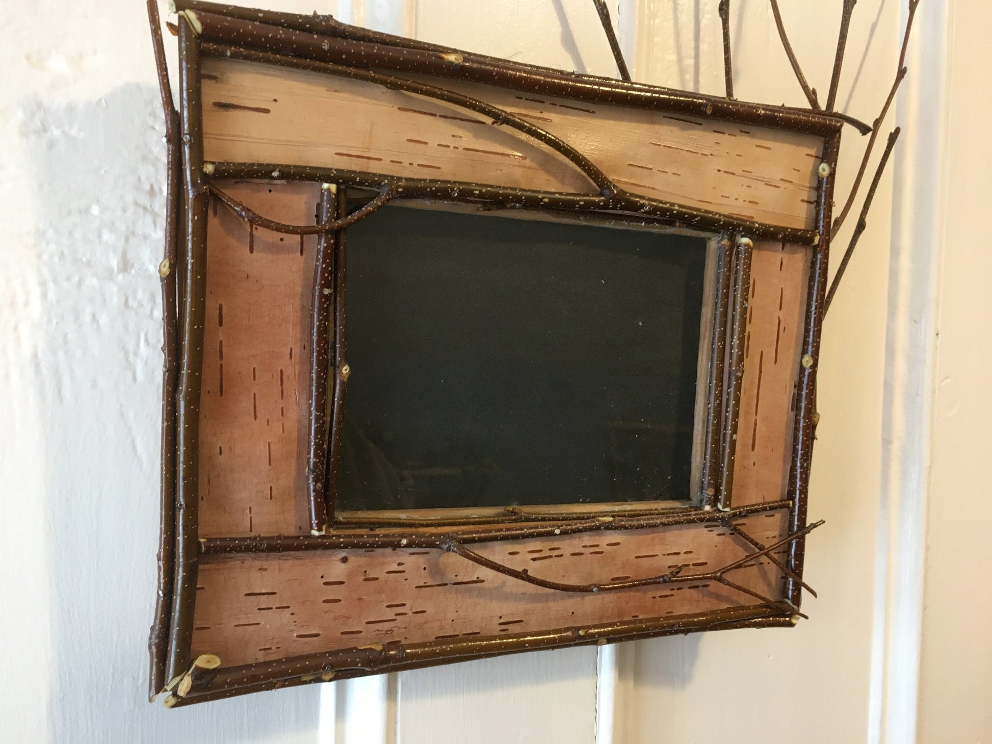 Adirondack picture frame crafted from birch bark and twigs, featuring natural textures and earthy tones, perfect for showcasing your favorite photo in a rustic, nature-inspired style