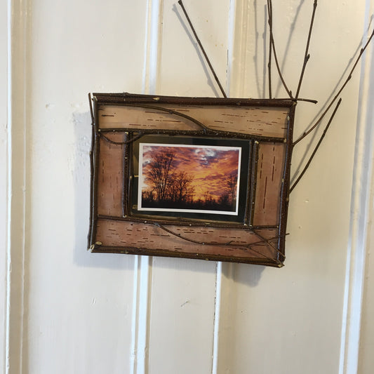 Adirondack picture frame crafted from birch bark and twigs, featuring natural textures and earthy tones, perfect for showcasing your favorite photo in a rustic, nature-inspired style