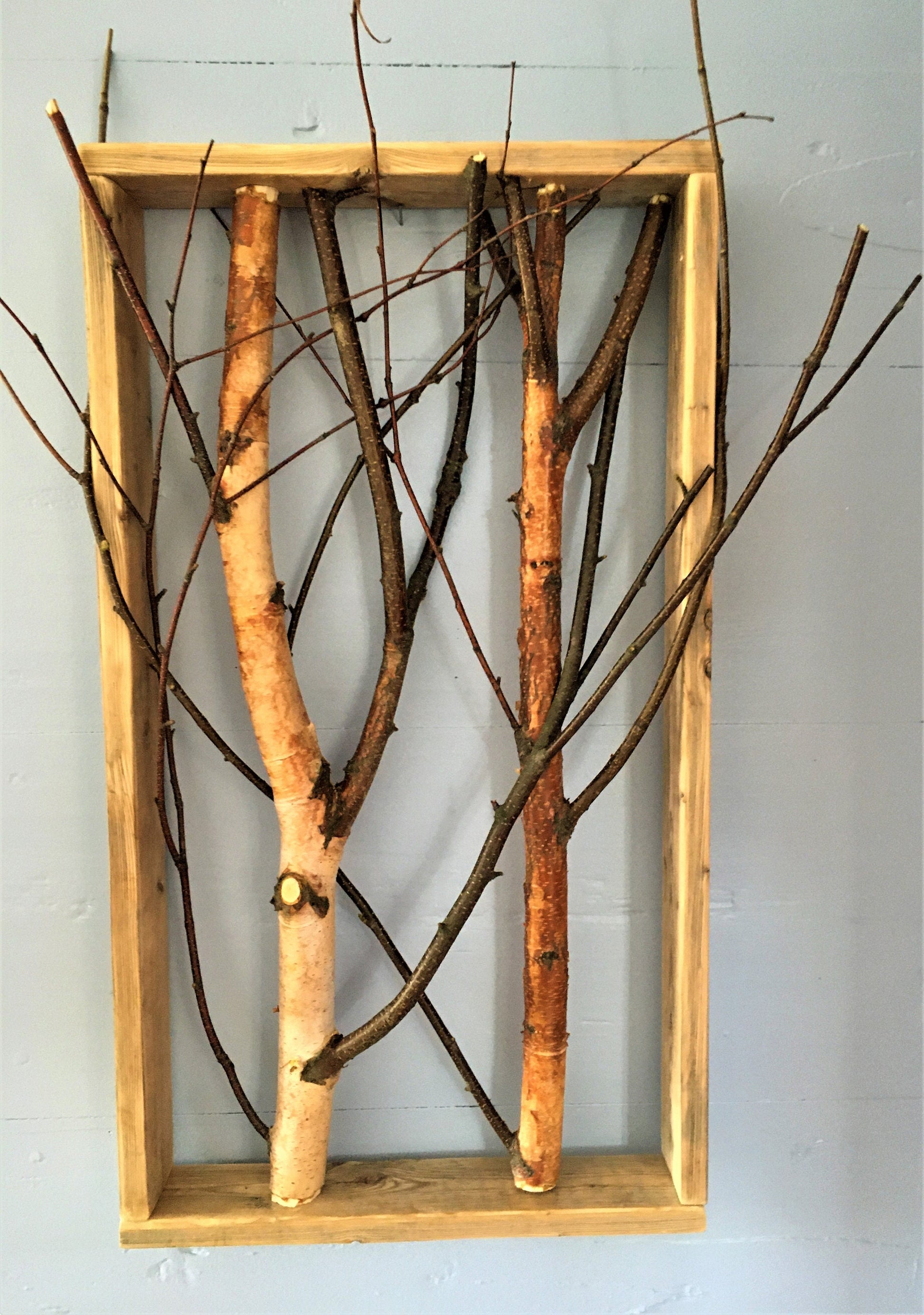 Birch branch shadow box wall decor featuring natural textures and earthy tones, perfect for adding a rustic touch to any interior space