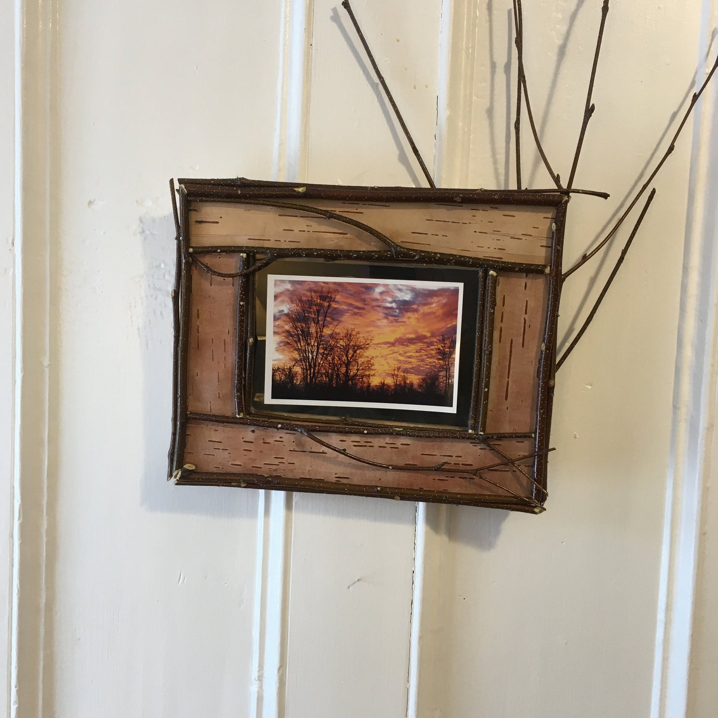 Adirondack picture frame crafted from birch bark and twigs, featuring natural textures and earthy tones, perfect for showcasing your favorite photo in a rustic, nature-inspired style